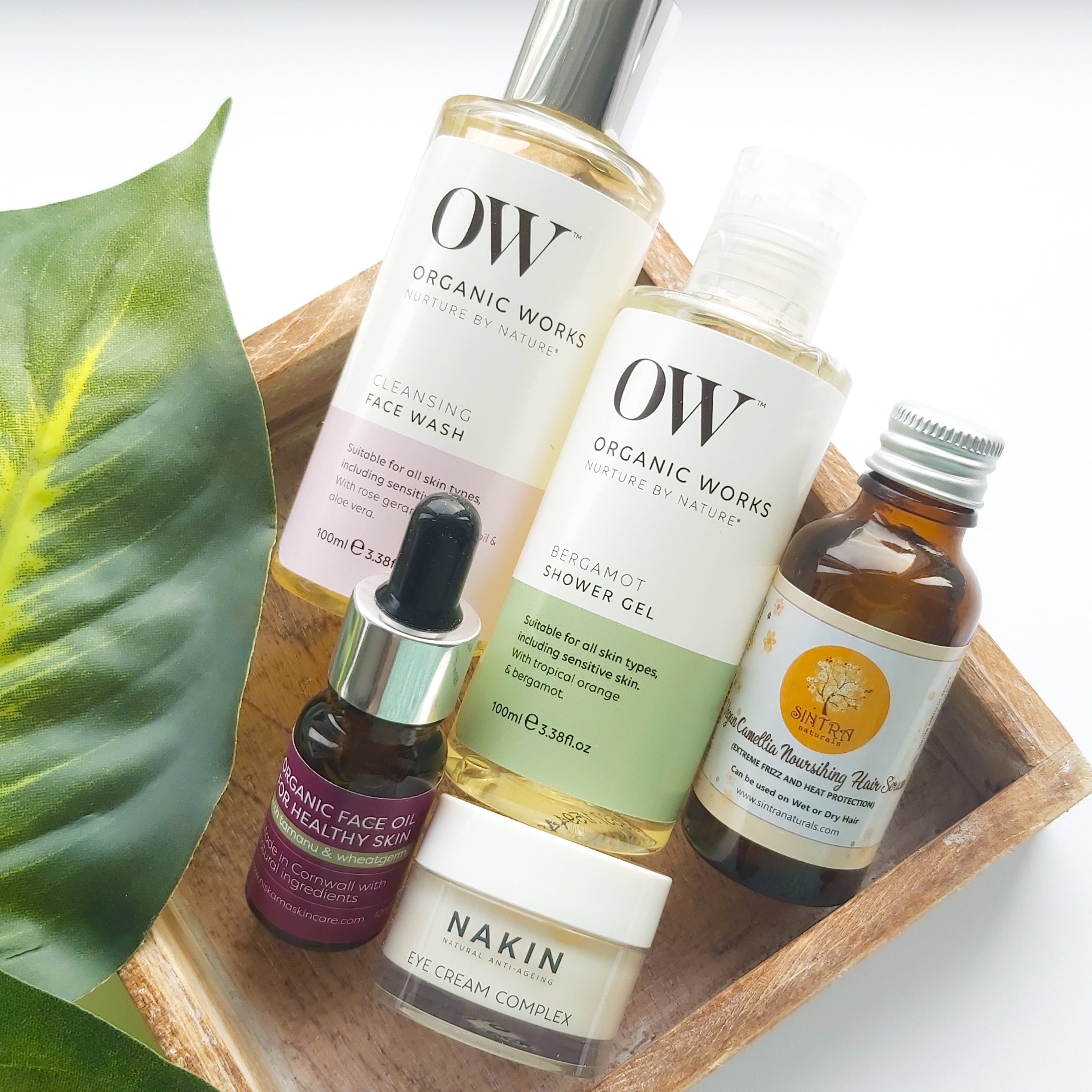 The items from The Natural Beauty Box May 2021 in a wooden tray with leaf - Review by Beauty Folio