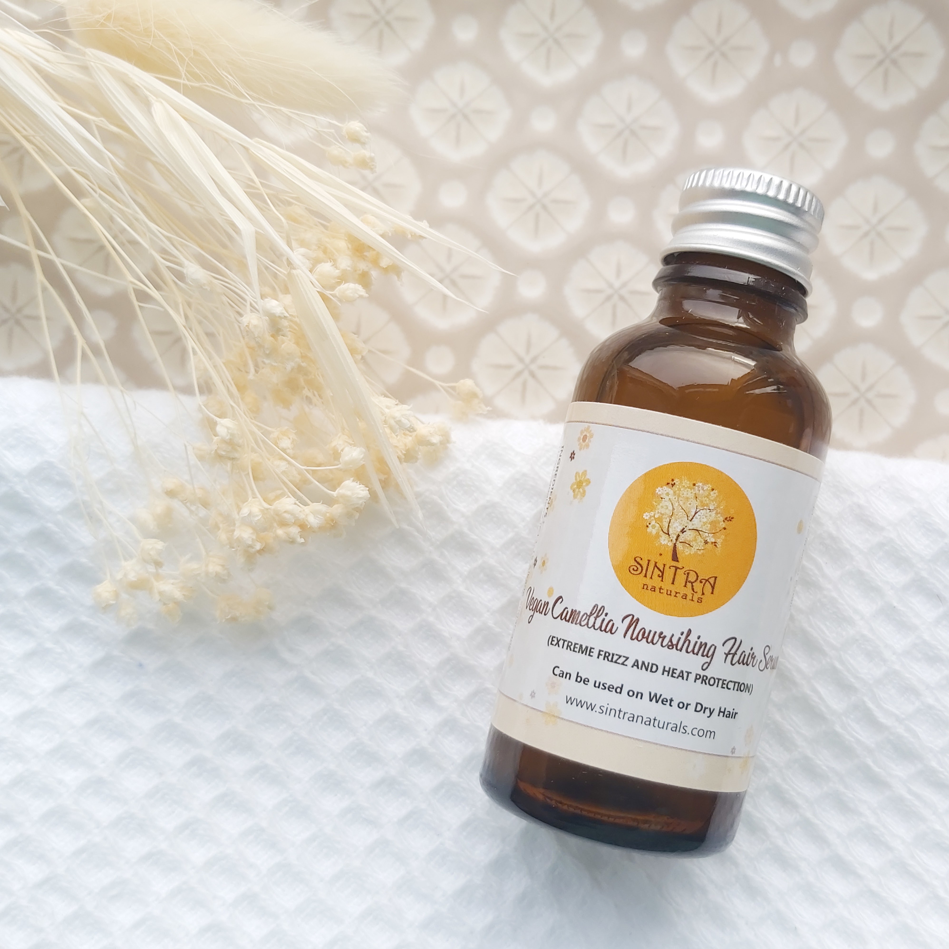 Sintra Naturals Vegan Camellia Nourishing Hair Serem featured in The Natural Beauty Box May 2021 on a patterned plate, waffle white towel and natural foliage - Review by Beauty Folio