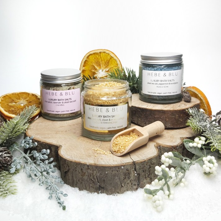 Hebe & Blu Skincare's Bath Salt Bundle Trio on a log slice with foliage. Natural Beauty Gift Guide by Beauty Folio