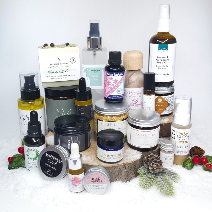 All natural beauty items featured stacked up together on a wood log slice. Natural Beauty Christmas Gift Guide by Beauty Folio 