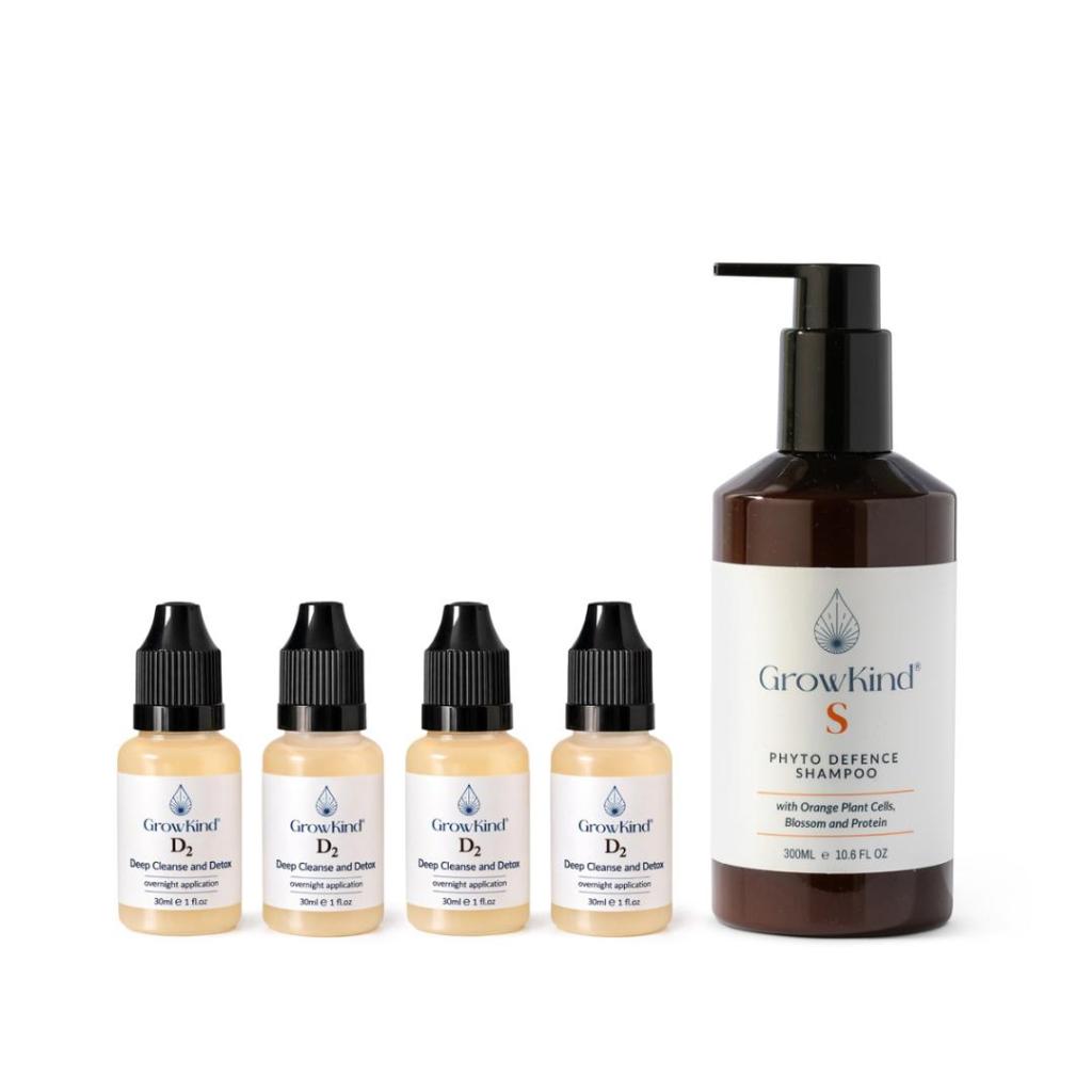 Four small bottles of GrowKind D2 Deep Cleanse and Detox treatment alongside a larger bottle of GrowKind S Phyto Defence Shampoo.